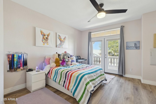 bedroom featuring baseboards, french doors, wood finished floors, and access to exterior