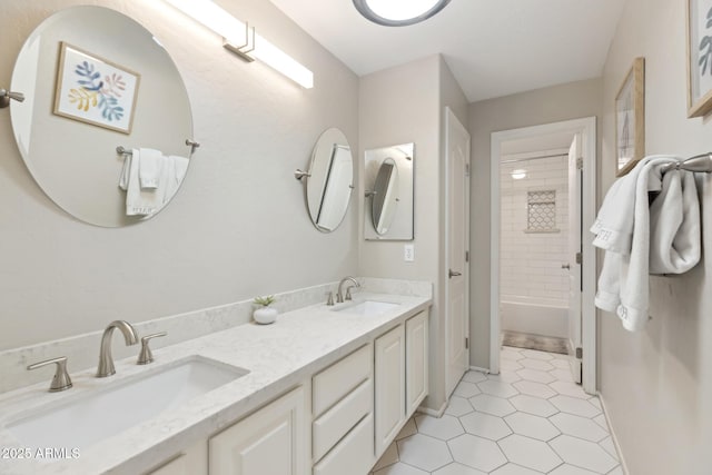 bathroom featuring shower / washtub combination, tile patterned flooring, a sink, and double vanity