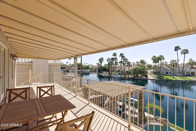 balcony with a residential view and a water view