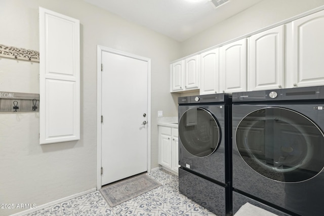 laundry area with cabinet space, light tile patterned floors, visible vents, baseboards, and separate washer and dryer