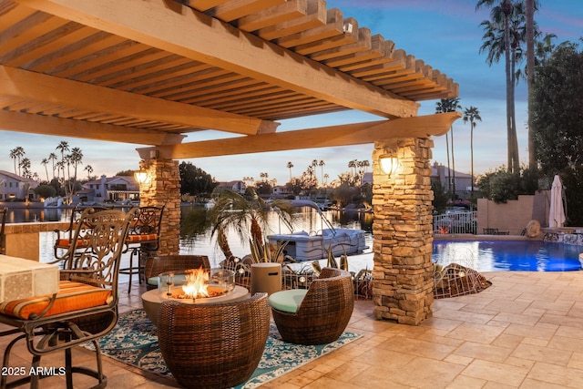 view of patio / terrace with an outdoor fire pit, an outdoor pool, and fence