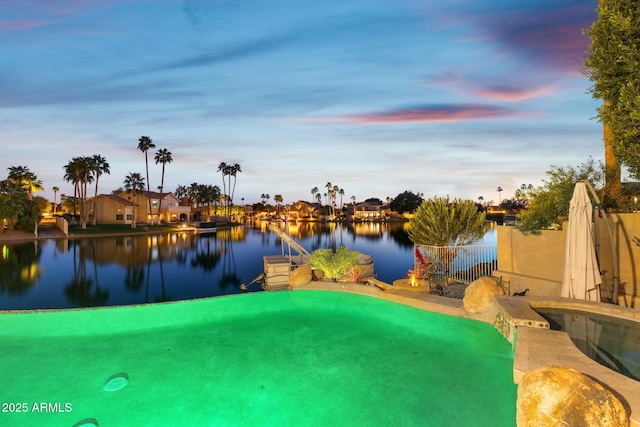 pool at dusk with a water view