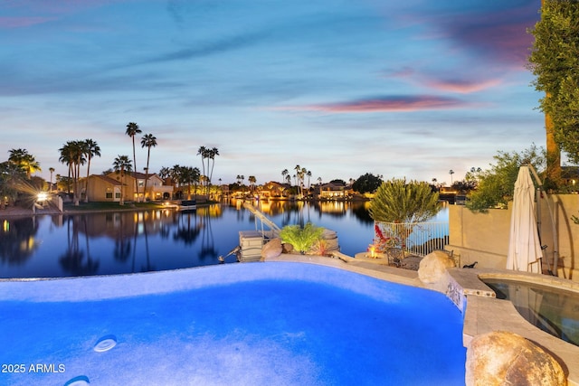 view of swimming pool with a water view