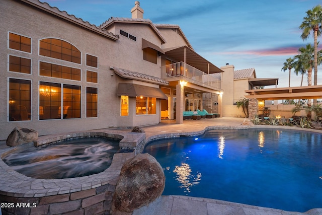 view of swimming pool featuring a fenced in pool, a patio, and an in ground hot tub