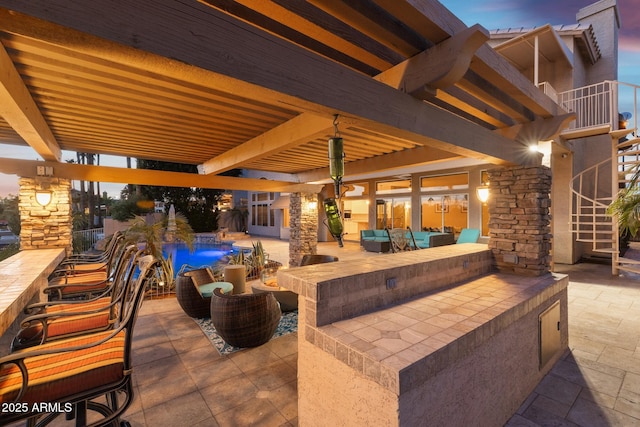 view of patio / terrace with an outdoor pool, a balcony, and an outdoor living space