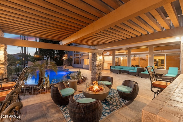 view of patio featuring an outdoor pool and an outdoor living space with a fire pit