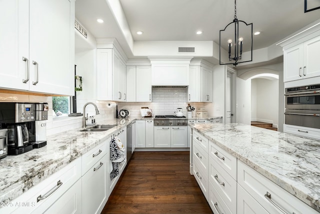 6556 N Arizona Biltmore Cir, Phoenix, AZ 85016 - kitchen with appliances with stainless steel finishes, white cabinetry, visible vents, and a sink