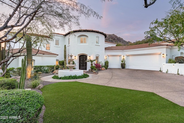 6556 N Arizona Biltmore Cir, Phoenix, AZ 85016 - mediterranean / spanish-style home with a front yard, stucco siding, a garage, and concrete driveway