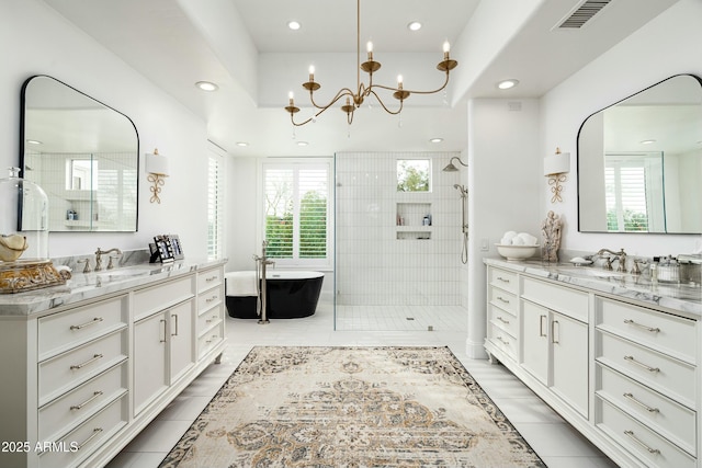 6556 N Arizona Biltmore Cir, Phoenix, AZ 85016 - bathroom with a sink, a shower stall, a notable chandelier, and visible vents