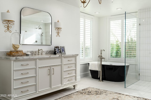 6556 N Arizona Biltmore Cir, Phoenix, AZ 85016 - bathroom featuring a freestanding tub, a wealth of natural light, a tile shower, and vanity