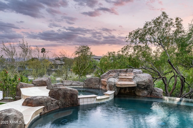 6556 N Arizona Biltmore Cir, Phoenix, AZ 85016 - pool at dusk featuring an in ground hot tub and an outdoor pool