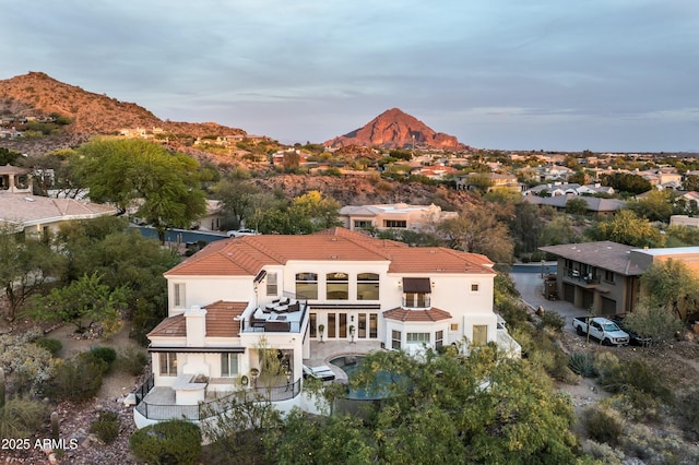 6556 N Arizona Biltmore Cir, Phoenix, AZ 85016 - rear view of house featuring a tiled roof, a balcony, a mountain view, and stucco siding
