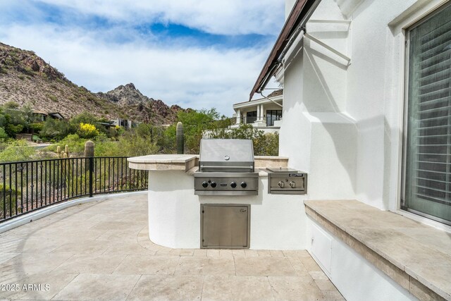 6556 N Arizona Biltmore Cir, Phoenix, AZ 85016 - view of patio / terrace with area for grilling, a mountain view, fence, and an outdoor kitchen