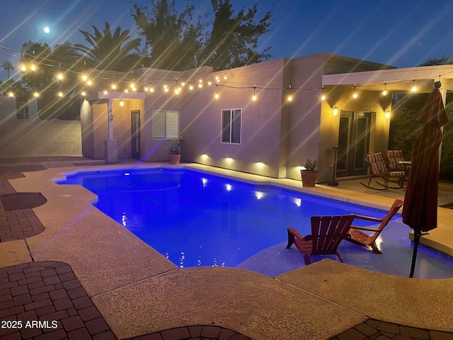 pool featuring fence and a patio