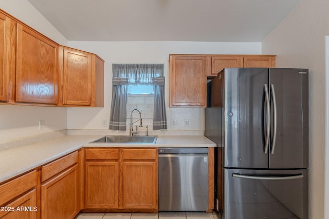 17403 N 16th Pl, Phoenix, AZ 85022 - kitchen featuring appliances with stainless steel finishes, a sink, light countertops, and brown cabinetry