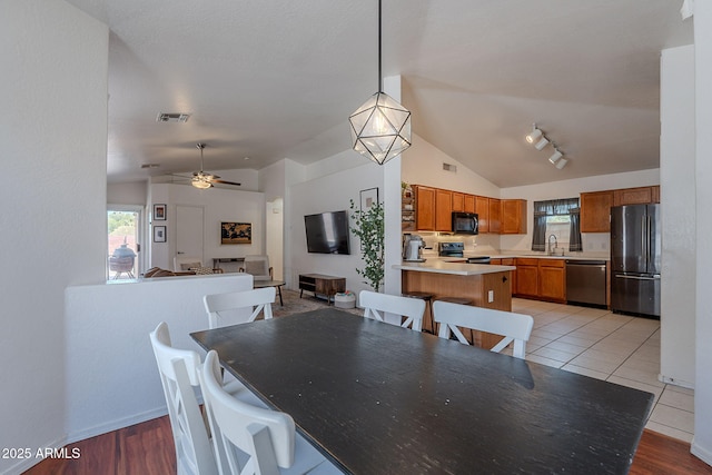 17403 N 16th Pl, Phoenix, AZ 85022 - dining space featuring vaulted ceiling, plenty of natural light, a ceiling fan, and baseboards