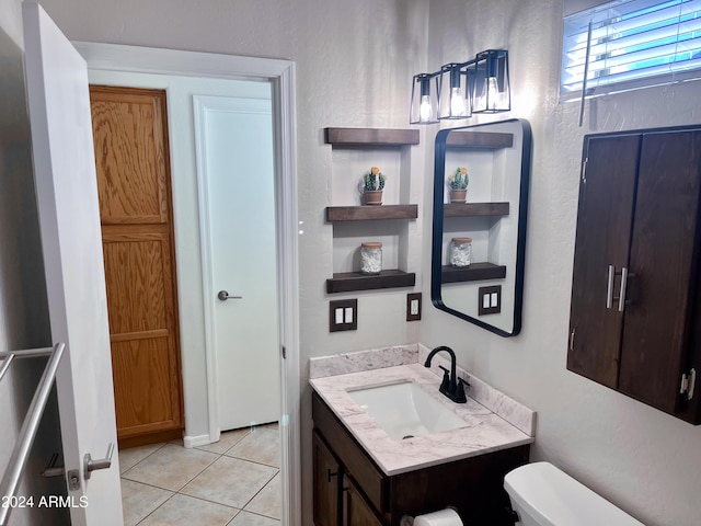 bathroom with tile patterned floors, vanity, and toilet