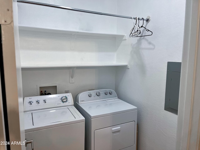 laundry room with electric panel and independent washer and dryer