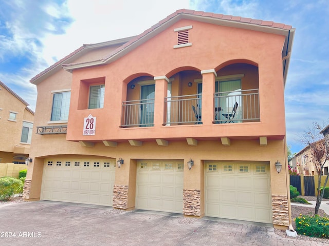 view of front of property with a balcony and a garage