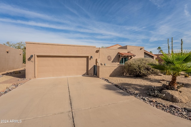 pueblo-style home with a garage