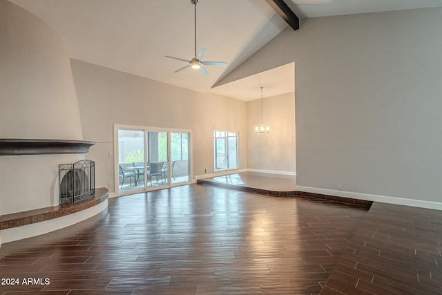 unfurnished living room with beam ceiling, ceiling fan with notable chandelier, high vaulted ceiling, and dark wood-type flooring