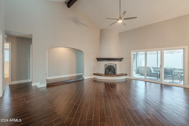 unfurnished living room with dark wood-type flooring and high vaulted ceiling