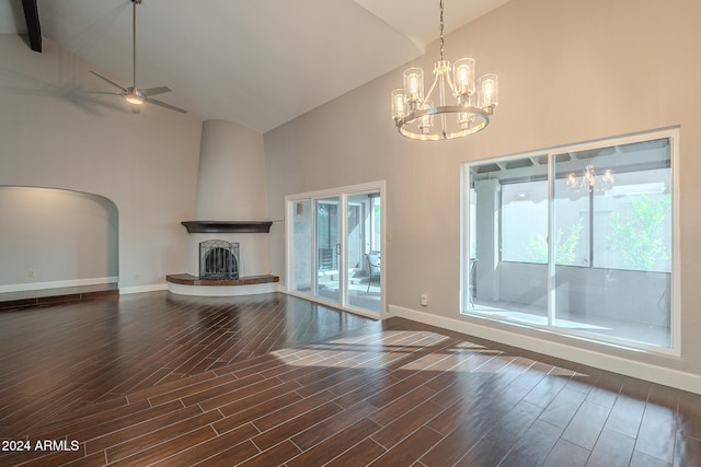 unfurnished living room featuring a fireplace, dark hardwood / wood-style flooring, high vaulted ceiling, and ceiling fan with notable chandelier