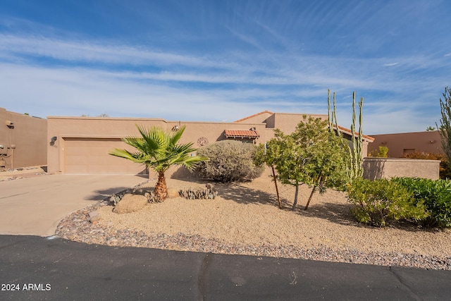 southwest-style home featuring a garage