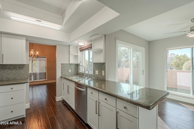 kitchen featuring decorative backsplash, white cabinets, sink, dishwasher, and dark hardwood / wood-style floors