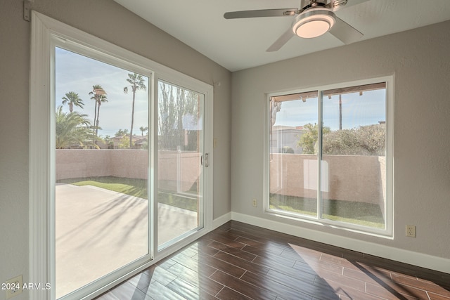 unfurnished room with ceiling fan and dark wood-type flooring