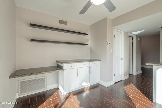 interior space featuring white cabinets, dark hardwood / wood-style flooring, and ceiling fan