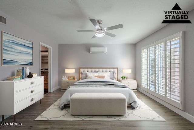 bedroom with ceiling fan, access to outside, dark wood-type flooring, and a wall unit AC