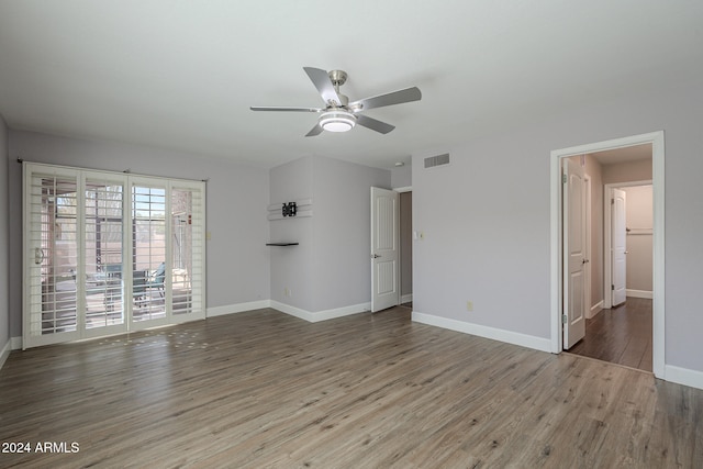 empty room featuring hardwood / wood-style floors and ceiling fan