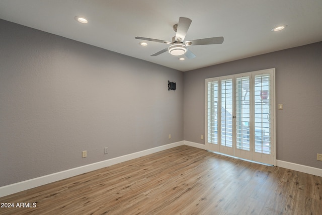 spare room featuring ceiling fan and light hardwood / wood-style flooring