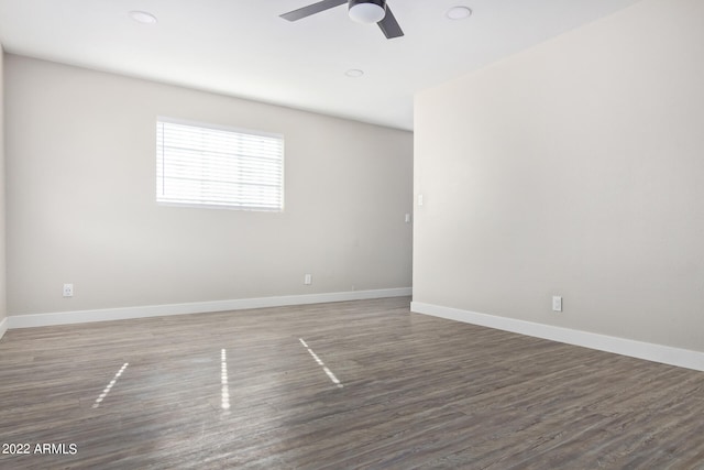 unfurnished room with ceiling fan and dark hardwood / wood-style flooring