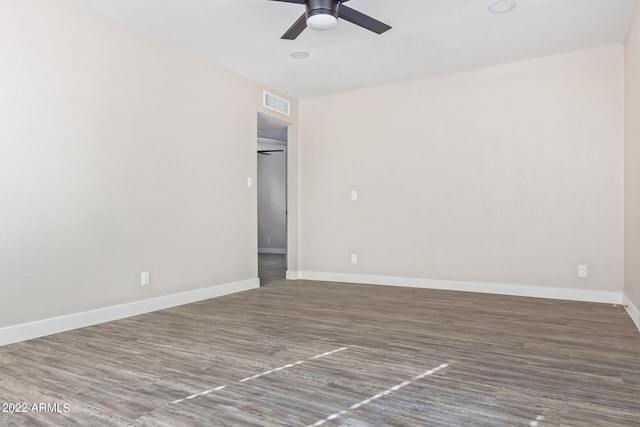 spare room featuring wood-type flooring and ceiling fan