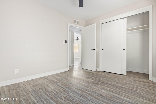 unfurnished bedroom featuring a closet, ceiling fan, and light wood-type flooring