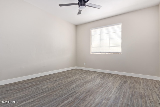 spare room with ceiling fan and dark wood-type flooring