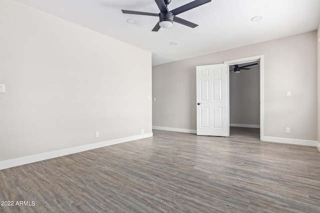 unfurnished room featuring dark hardwood / wood-style floors and ceiling fan