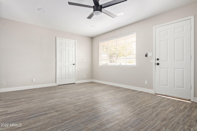 spare room with dark hardwood / wood-style floors and ceiling fan