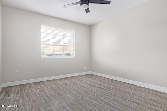 empty room with ceiling fan and hardwood / wood-style floors