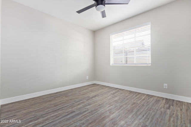 unfurnished room featuring dark hardwood / wood-style flooring and ceiling fan