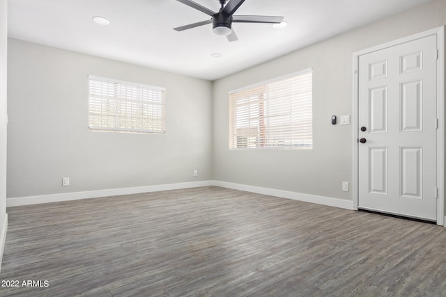 empty room featuring ceiling fan and dark hardwood / wood-style flooring