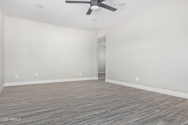 spare room featuring dark hardwood / wood-style floors and ceiling fan