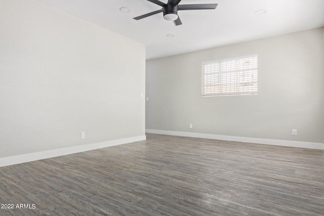 spare room featuring ceiling fan and dark hardwood / wood-style floors