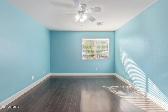 empty room featuring dark hardwood / wood-style flooring and ceiling fan