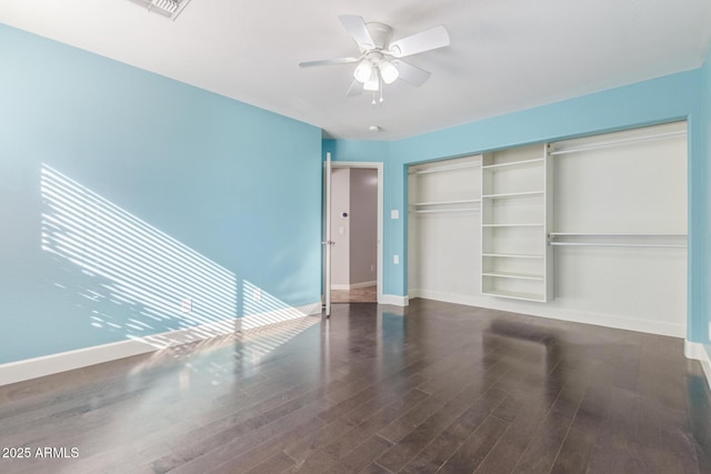 unfurnished bedroom featuring a closet, ceiling fan, and dark wood-type flooring