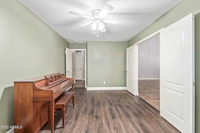 misc room with ceiling fan and dark hardwood / wood-style floors