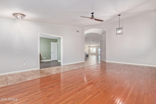 unfurnished room featuring ceiling fan and hardwood / wood-style floors