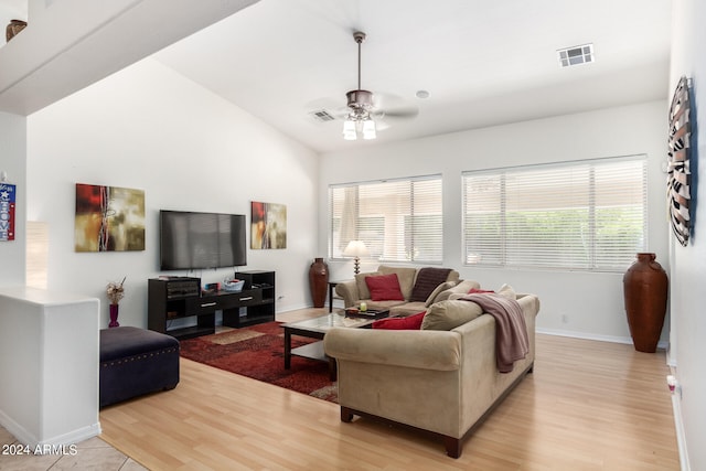 living room featuring a healthy amount of sunlight, light hardwood / wood-style floors, and ceiling fan